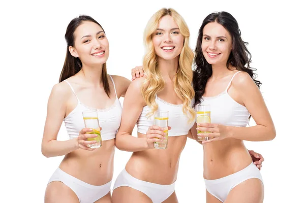 Women holding glasses of water with lemon — Stock Photo