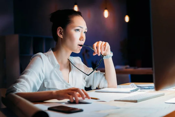 Empresaria que trabaja hasta tarde en la oficina - foto de stock