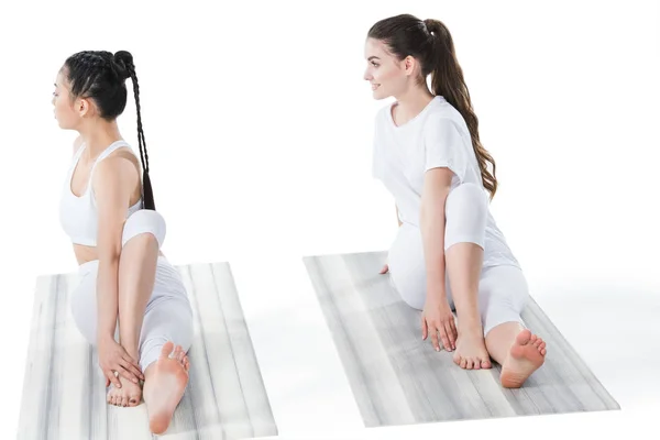 Women doing twisting sage pose — Stock Photo