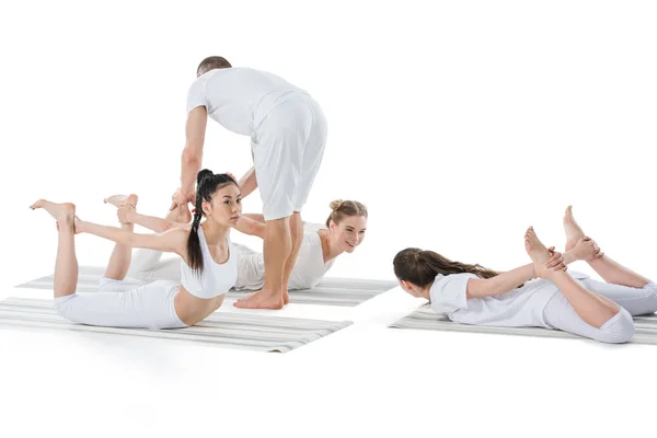 Girls doing Frog Pose with instructor — Stock Photo