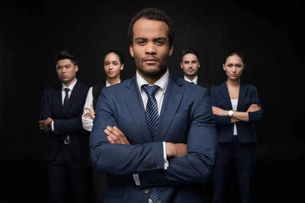 Confident businessman with his colleagues — Stock Photo