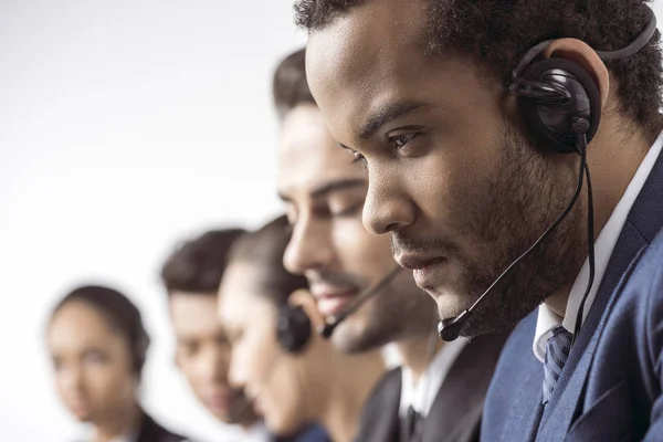 Call center operators in headsets — Stock Photo