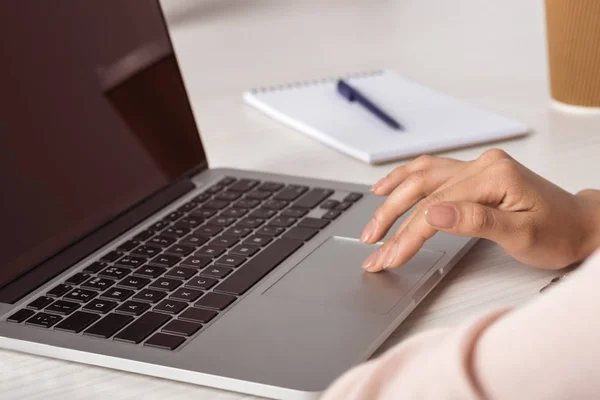 Businesswoman working on laptop at office — Stock Photo