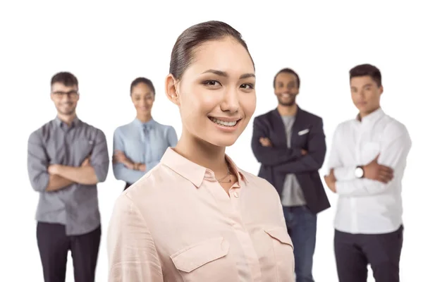 Businesswoman standing in front of colleagues — Stock Photo