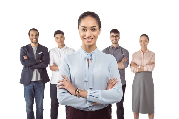 Businesswoman standing in front of colleagues — Stock Photo