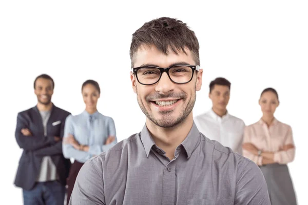 Businessman standing in front of colleagues — Stock Photo