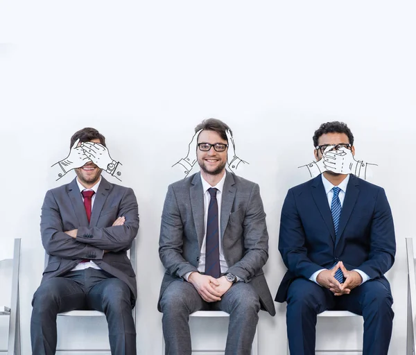 Businessmen sitting on chairs — Stock Photo