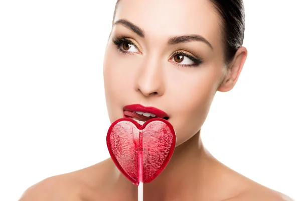 Woman with heart shaped lollipop — Stock Photo