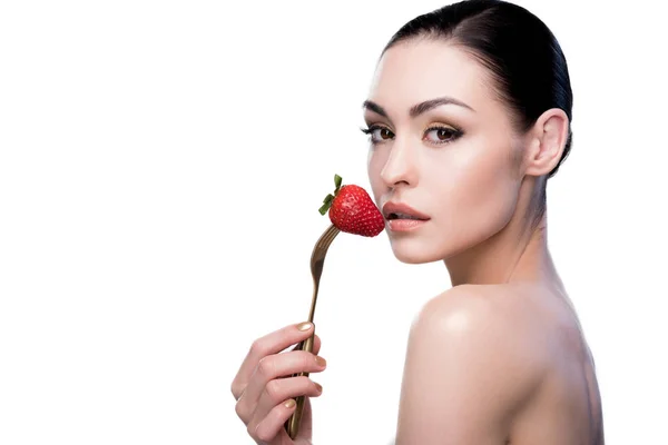 Woman with strawberry on fork — Stock Photo