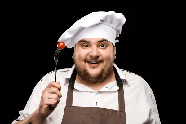 Chef sosteniendo tomate en tenedor — Stock Photo