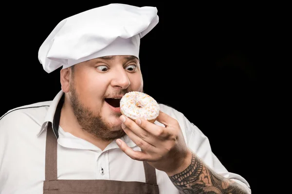 Chef holding doughnut — Stock Photo