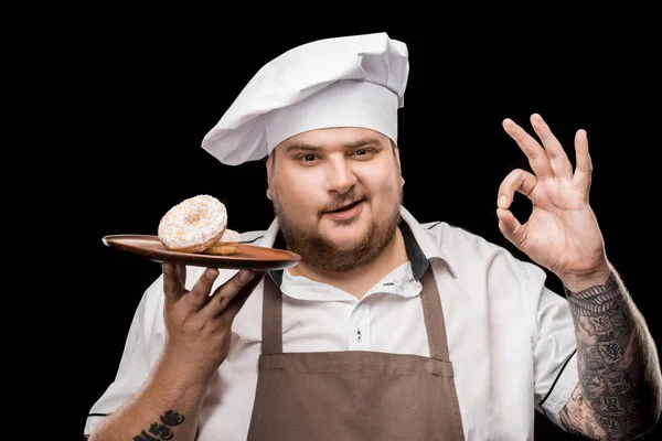 Chef con rosquillas en plato - foto de stock