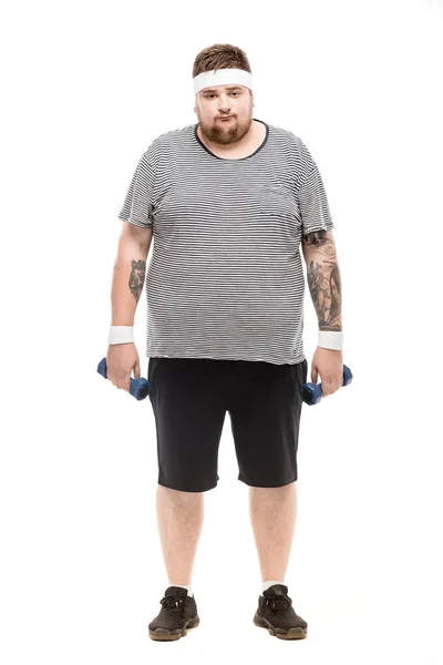 Chubby man holding dumbbells — Stock Photo