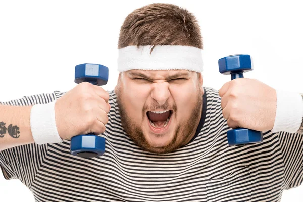 Chubby man yelling while holding dumbbells — Stock Photo