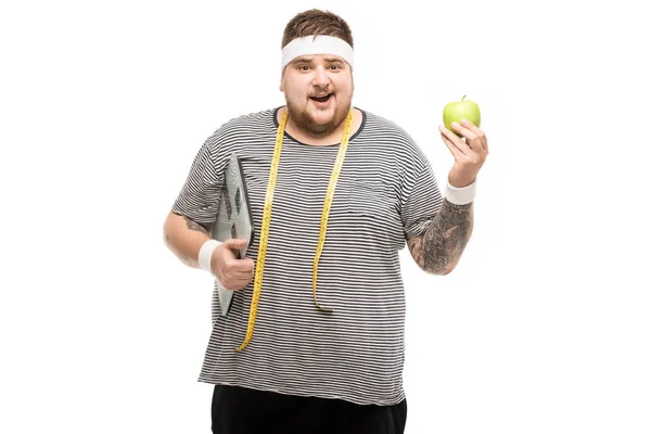 Mann mit Körperwaage und Apfel — Stockfoto
