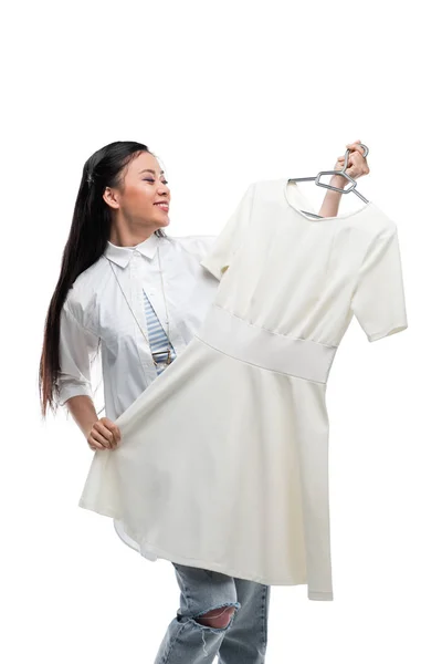 Asian girl holding dress — Stock Photo