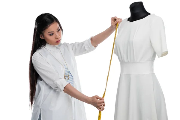 Fashion designer measuring dress on dummy — Stock Photo