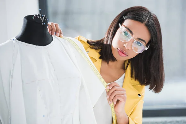 Dressmaker working with dummy — Stock Photo