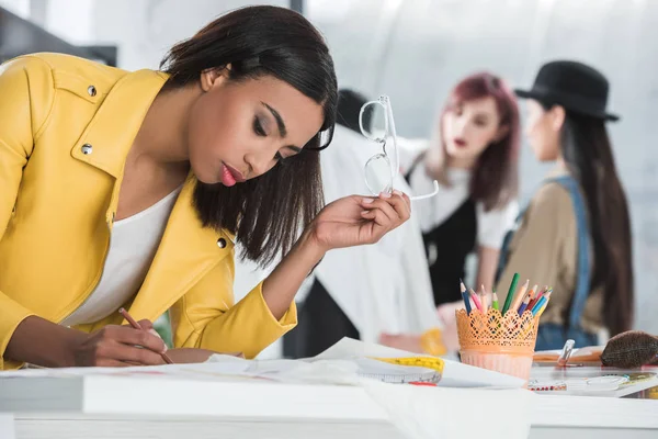 Fashion designer working on sketch — Stock Photo