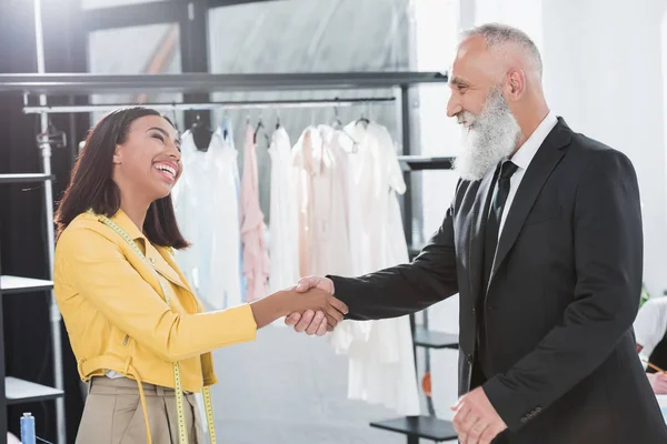 Stylist greeting grey haired customer — Stock Photo