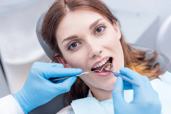 Dentista examinando los dientes pacientes - foto de stock