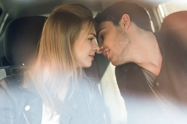 Мужчина целует девушку в машине — стоковое фото