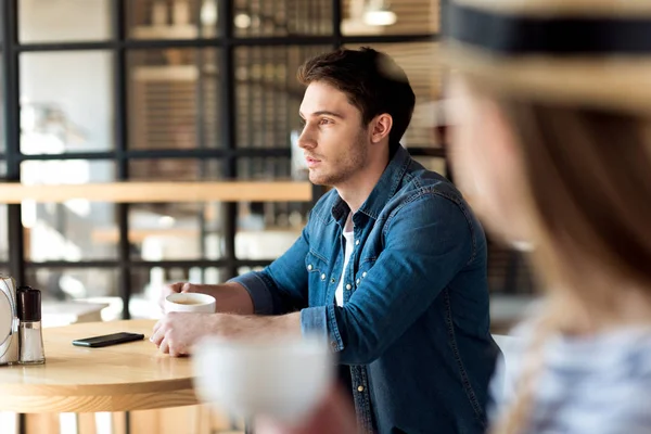 Man with cup of coffee in cafe — Stock Photo