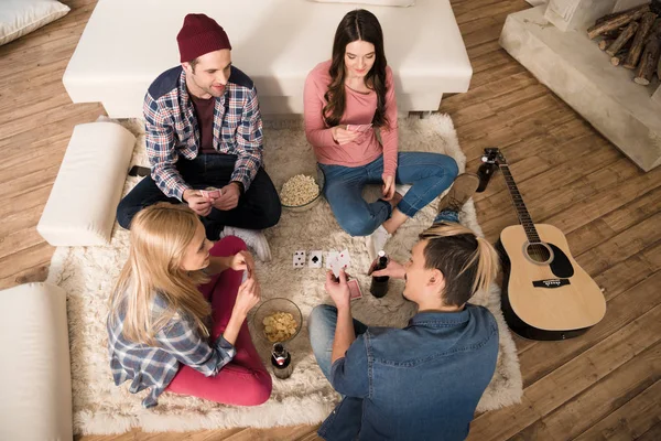 Top view of men and women playing cards — Stock Photo