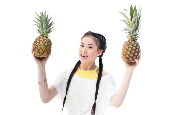 Asian woman with pineapples — Stock Photo