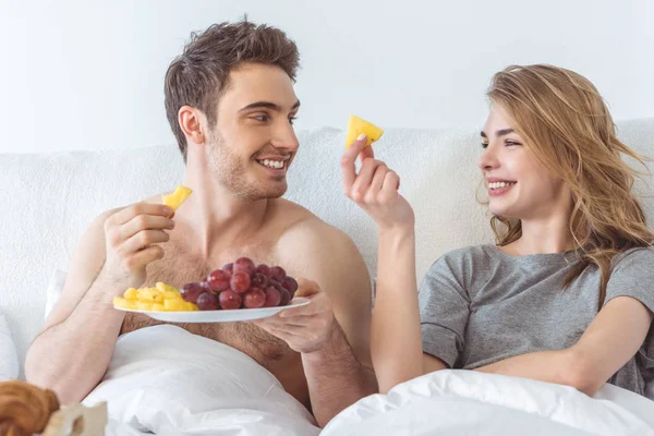 Couple with breakfast in bed — Stock Photo