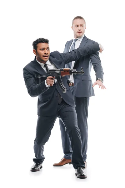 Bodyguard with rifle and client — Stock Photo