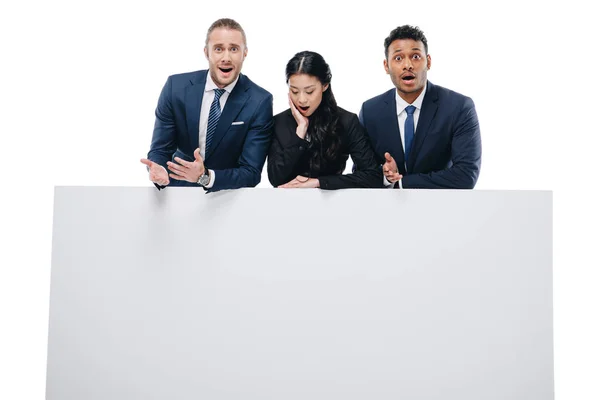 Shocked businesspeople with empty board — Stock Photo