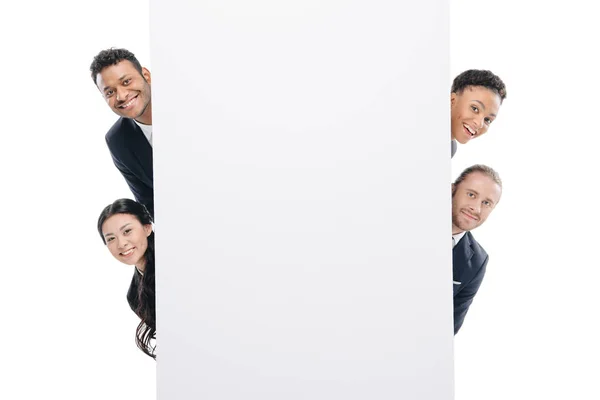 Multiethnic businesspeople with empty board — Stock Photo