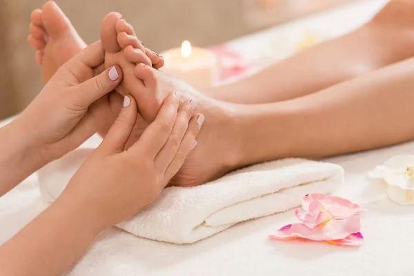Massage therapist making feet massage — Stock Photo