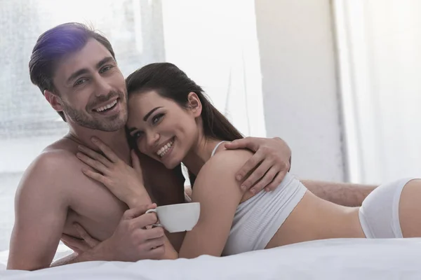 Couple in bed with coffee — Stock Photo