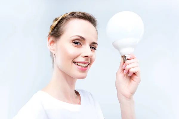 Woman with light bulb — Stock Photo