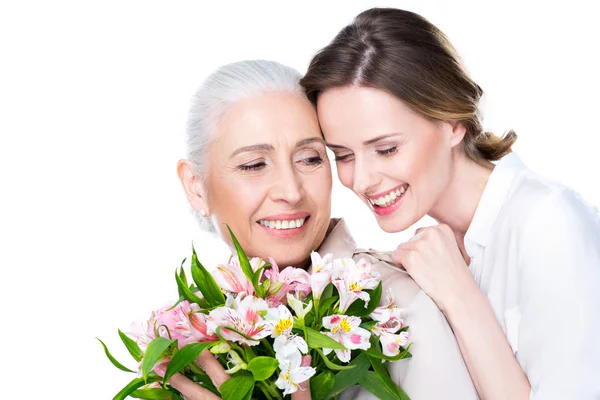 Adult daughter and mother with bouquet — Stock Photo