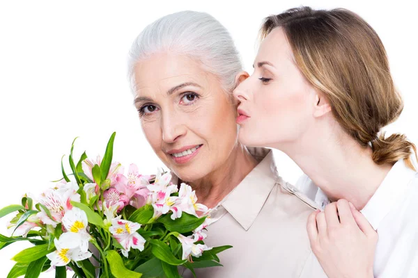 Adult daughter kissing her mother — Stock Photo