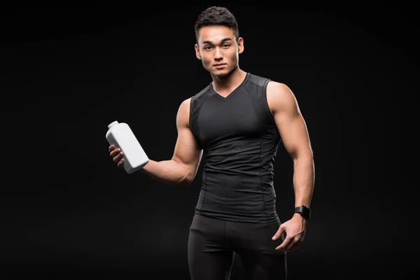 Muscular man with sport nutrition — Stock Photo