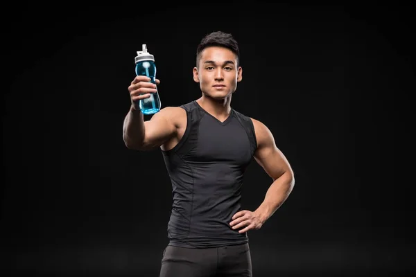 Asian sportsman with sports bottle — Stock Photo