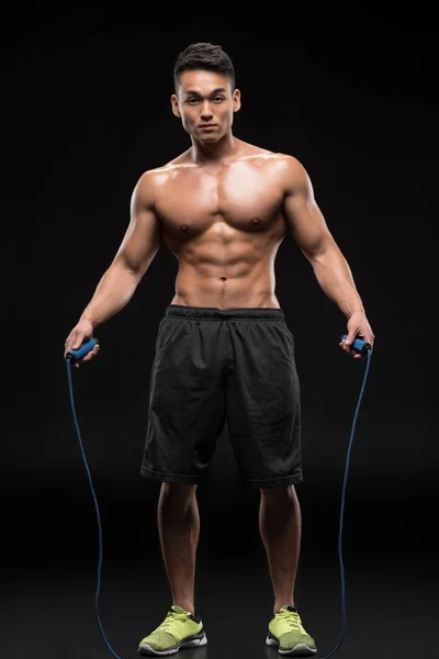 Muscular man with skipping rope — Stock Photo