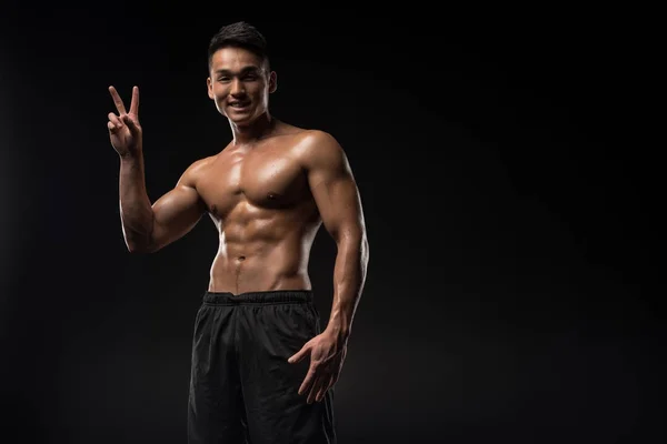 Sportsman showing victory sign — Stock Photo