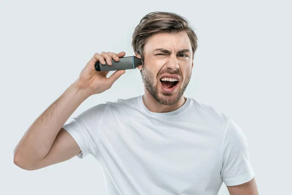 Man using electric trimmer — Stock Photo