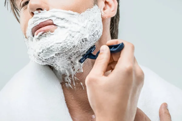 Man in foam shaving with razor — Stock Photo