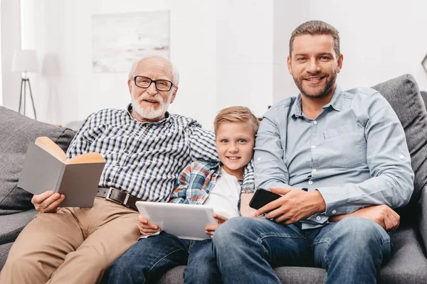 Family relaxing on couch at home — Stock Photo
