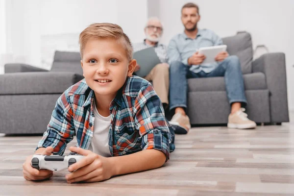 Little boy playing videogames with gamepad — Stock Photo