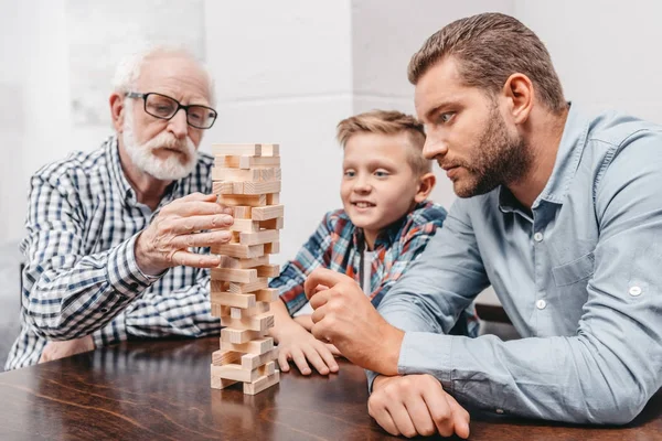 Family playing wood block game — Stock Photo