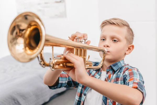 Boy practicing trumpet — Stock Photo