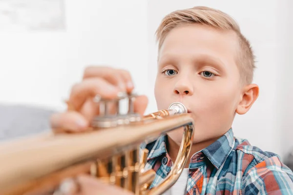 Boy practicing trumpet — Stock Photo