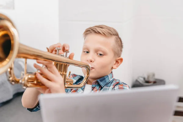 Boy practicing trumpet — Stock Photo
